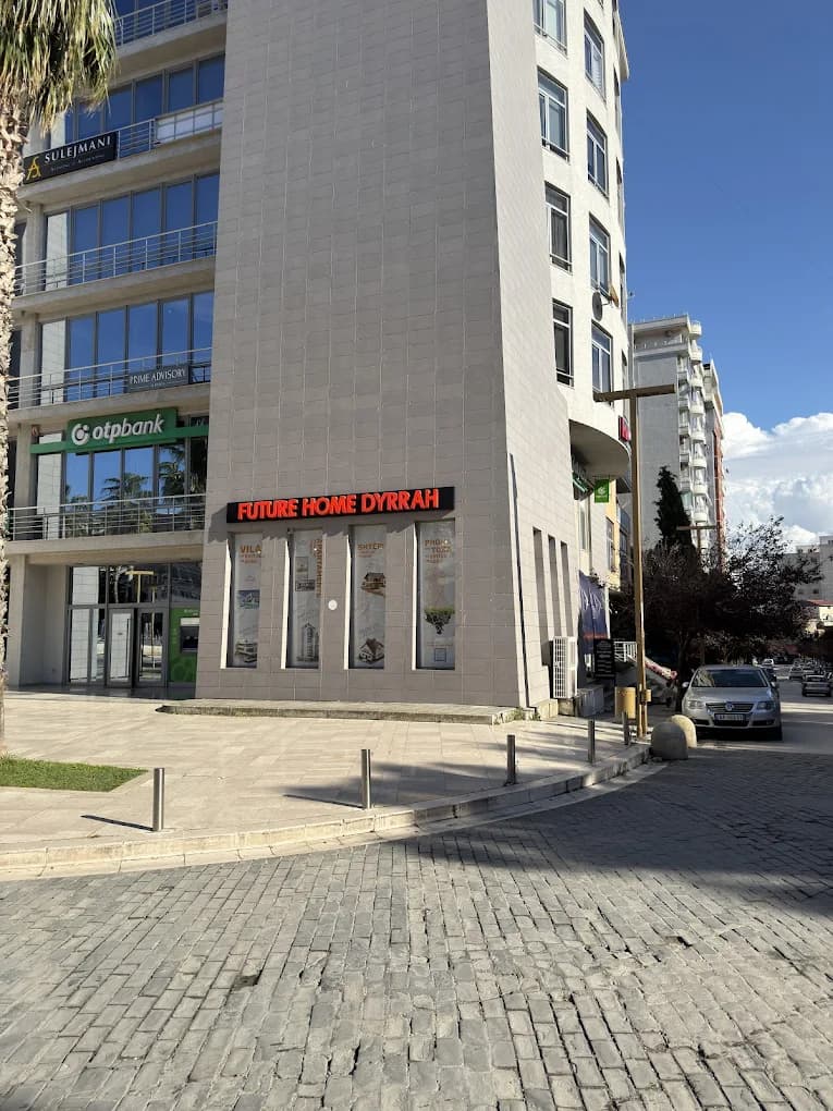 Future Home Dyrrah office on Sheshi Liria, Durrës — corner storefront with the company sign visible.